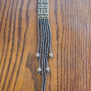 Three strand charcoal grey pearls.